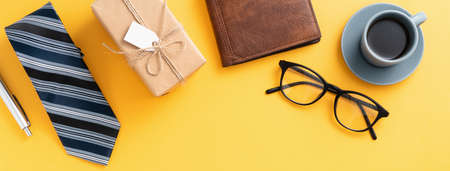 Father's day gift background design concept with gift box idea and necktie on yellow background.の写真素材