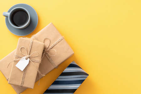 Father's day gift background design concept with gift box idea and necktie on yellow background.