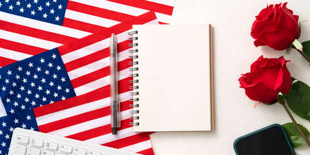 Concept of Independence day or Memorial day with national flag, rose and office supplies on white table background.の写真素材