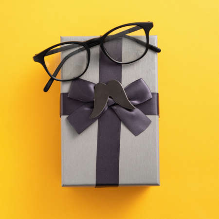 Father's day gift idea design concept with gift box on yellow background.の写真素材