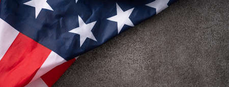 Concept of US Independence day or Memorial day. National flag over dark gray table background.