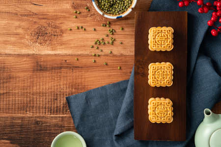 Delicious mung bean moon cake for Mid-Autumn Festival food mooncake on dark wood table background...
