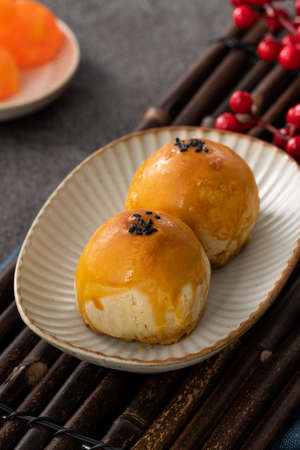 Design concept of Moon cake yolk pastry, mooncake for Mid-Autumn Festival holiday on dark gray table backgroundの写真素材