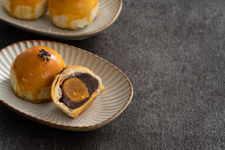 Design concept of Moon cake yolk pastry, mooncake for Mid-Autumn Festival holiday on dark gray table backgroundの写真素材