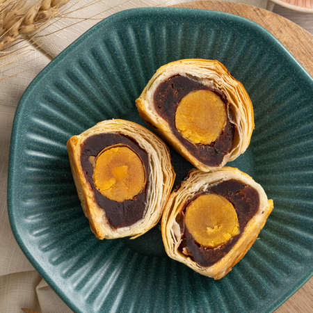 Design concept of Moon cake yolk pastry, mooncake for Mid-Autumn Festival holiday on wooden table...