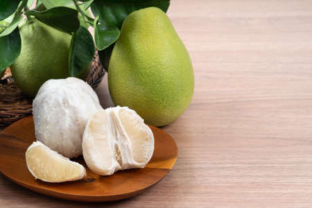 Close up of fresh peeled pomelo on wooden table background for Mid-Autumn Festival fruit.の写真素材