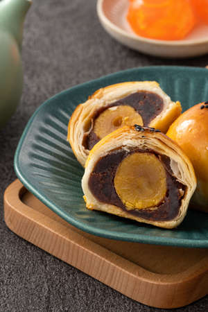 Design concept of Moon cake yolk pastry, mooncake for Mid-Autumn Festival holiday on dark gray table backgroundの写真素材