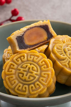 Delicious Cantonese moon cake for Mid-Autumn Festival food mooncake on gray table background for afternoon tea, holiday celebration serving.の写真素材