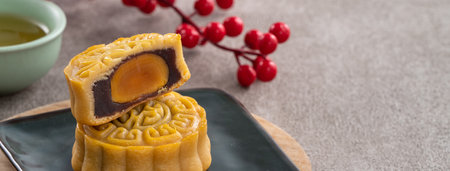Delicious Cantonese moon cake for Mid-Autumn Festival food mooncake on gray table background for afternoon tea, holiday celebration serving.の写真素材