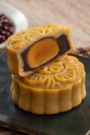 Delicious Cantonese moon cake for Mid-Autumn Festival food mooncake on wooden table background for...