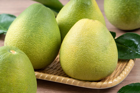 Close up of fresh peeled pomelo on wooden table background for Mid-Autumn Festival fruit.