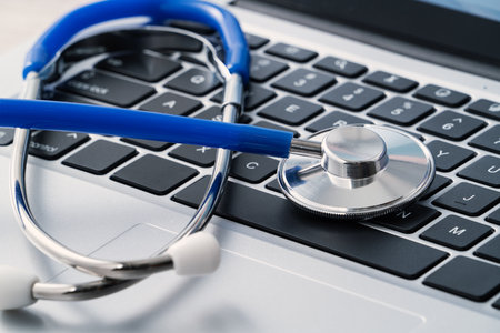 Doctor diagnoses design concept - stethoscope on computer keyboard on white working table.の写真素材