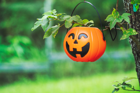 Cute Halloween decorations hanging on a tree in the forest to celebrate Halloween, festive holiday...