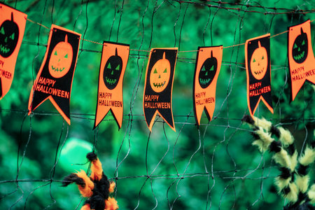 Cute Halloween decorations hanging on a tree in the forest to celebrate Halloween, festive holiday design concept.の写真素材