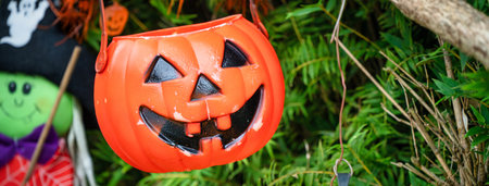 Cute Halloween decorations hanging on a tree in the forest to celebrate Halloween, festive holiday...