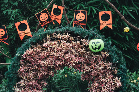 Cute Halloween decorations hanging on a tree in the forest to celebrate Halloween, festive holiday design concept.の写真素材