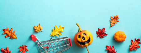 Creative Halloween autumn shopping design concept decoration on blue paper table background with...
