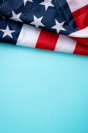 United States election design concept, top view of American Flag over blue table background.