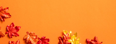 Maple leaves isolated on orange table background for design elements in autumn season.