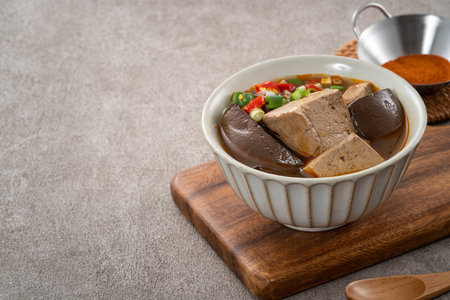 Delicious spicy duck blood jelly soup bowl and stinky tofu with scallion and chili pepper topping.