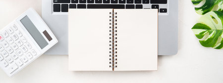Annual financial budget and saving plan design concept with laptop, piggy bank, calculator and notebook with copy space on white table background.の写真素材