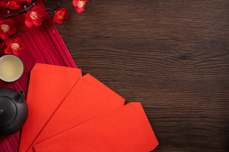 Design concept of Chinese lunar new year background with red plum flower, red envelope and festive decorations with copy space.の写真素材