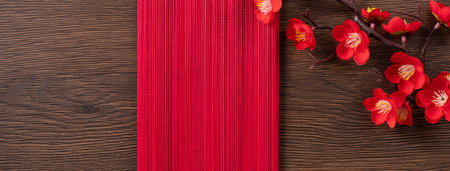 Design concept of Chinese lunar new year background with red plum flower, red envelope and festive decorations with copy space.の写真素材