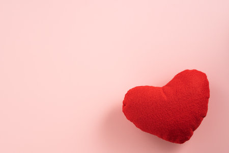 Valentine's Day design concept of beautiful red heart on pink background with copy space.の写真素材