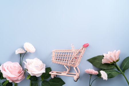 Valentine's Day and Mother's Day gift shopping design concept background with pink rose, carnation flower and wrapped gift box on blue table background.の写真素材