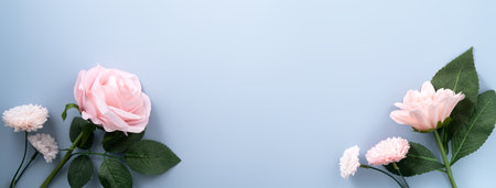 Valentine's Day and Mother's Day gift shopping design concept background with pink rose, carnation flower and wrapped gift box on blue table background.の写真素材