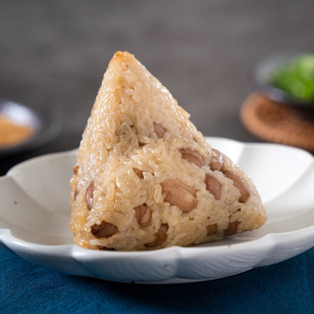 Vegetable zongzi. Vegetarian rice dumpling for traditional Chinese Duanwu Dragon Boat Festival food with glutinous rice, peanuts, and coriander.の写真素材