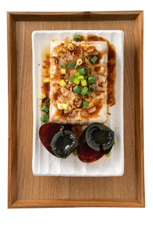 Delicious Chilled tofu and century egg food with soy sauce and bonito flakes topping in Taiwan.の写真素材