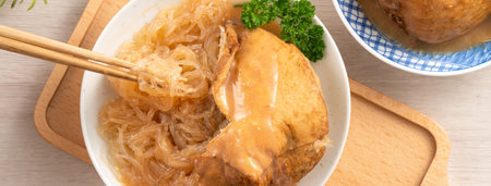 Tamsui agei (age, aburaage, ageh), delicious street food in Taiwan, stuffed with mung bean noodles and sauce topping.の写真素材