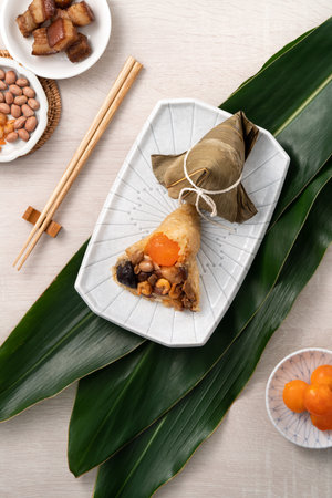 Zongzi. Rice dumpling for Chinese traditional Dragon Boat Festival (Duanwu Festival) on bright wooden table background with ingredient.の写真素材