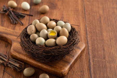 Fresh button quail eggs in a nest on wooden table background.の写真素材