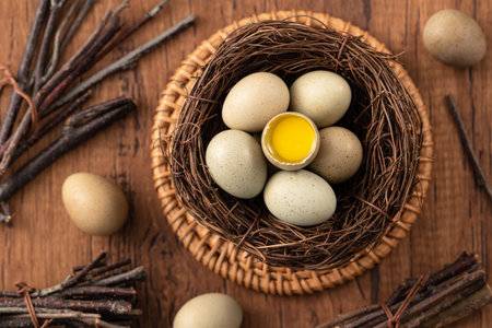 Top view of fresh button quail eggs in a nest on wooden table background.の写真素材