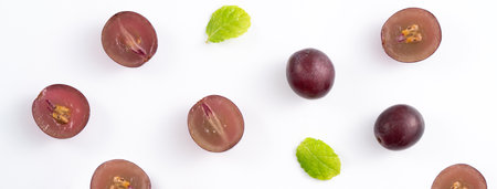 Delicious bunch of purple grapes fruit spilled over white table background.の写真素材