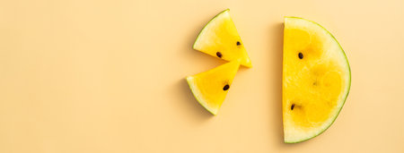 Sliced yellow golden watermelon pattern flat lay on pastel yellow table background.の写真素材