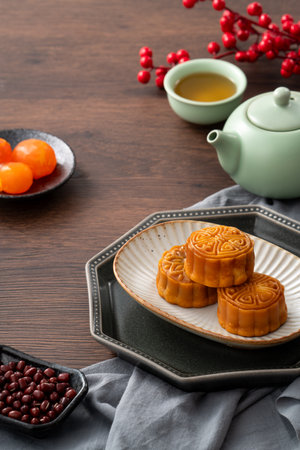 Delicious Cantonese moon cake for Mid-Autumn Festival food mooncake on wooden table background for afternoon tea, holiday celebration serving.の写真素材
