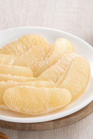 Close up of fresh peeled pomelo on wooden table background for Mid-Autumn Festival fruit.の写真素材