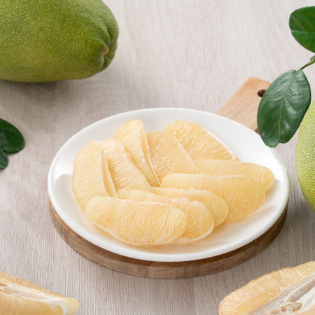 Close up of fresh peeled pomelo on wooden table background for Mid-Autumn Festival fruit.の写真素材