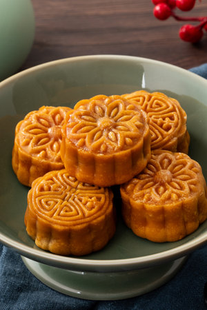 Delicious Cantonese moon cake for Mid-Autumn Festival food mooncake on wooden table background for afternoon tea, holiday celebration serving.の写真素材