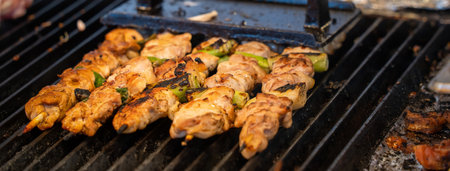 Grilling barbecue meat skewer kebab at traditional night market stall, delicious street food in South Korea.の写真素材