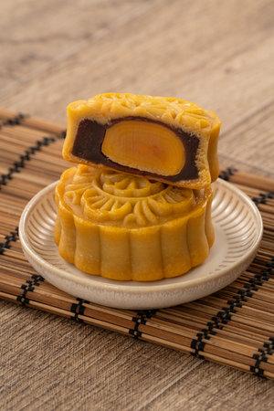 Delicious Cantonese moon cake for Mid-Autumn Festival food mooncake on wooden table background for afternoon tea, holiday celebration serving.の写真素材