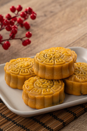 Delicious Cantonese moon cake for Mid-Autumn Festival food mooncake on wooden table background for afternoon tea, holiday celebration serving.の写真素材