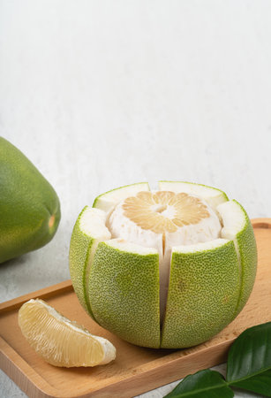 Fresh peeled pomelo on gray table background for Mid-Autumn Festival fruit.