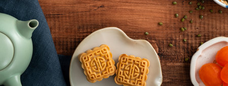 Delicious mung bean moon cake for Mid-Autumn Festival food mooncake on wooden table background for afternoon tea, holiday celebration serving.の写真素材