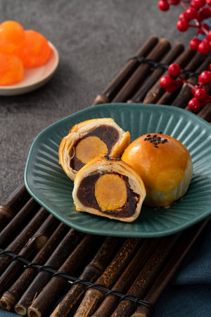 Design concept of Moon cake yolk pastry, mooncake for Mid-Autumn Festival holiday on dark gray table backgroundの写真素材
