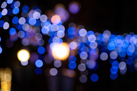 Blurred light halo, string light spot with black dark background at night.の写真素材