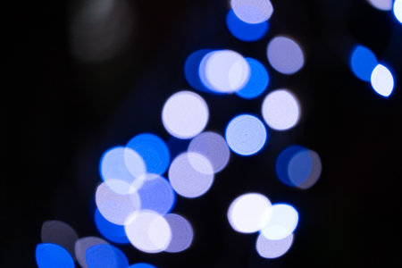 Blurred light halo, string light spot with black dark background at night.の写真素材